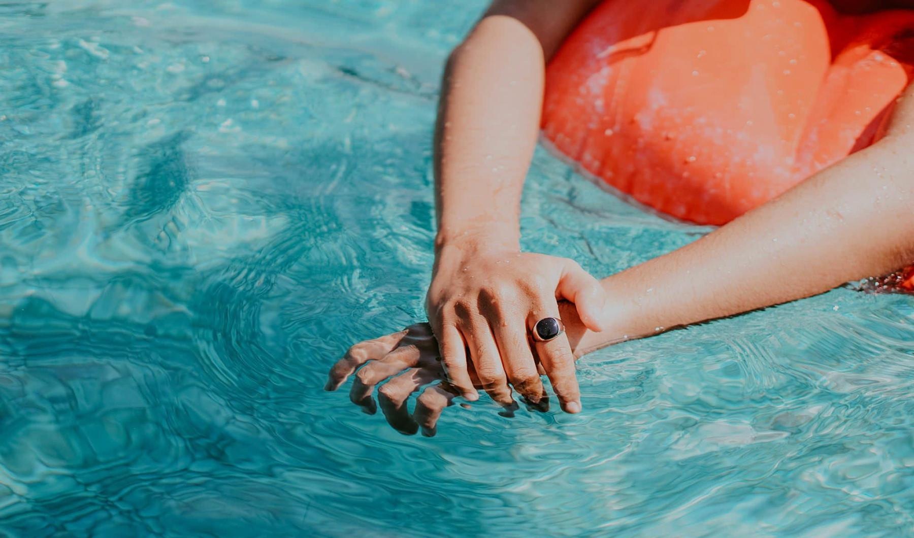 woman relaxes on a floatie in swimming pool