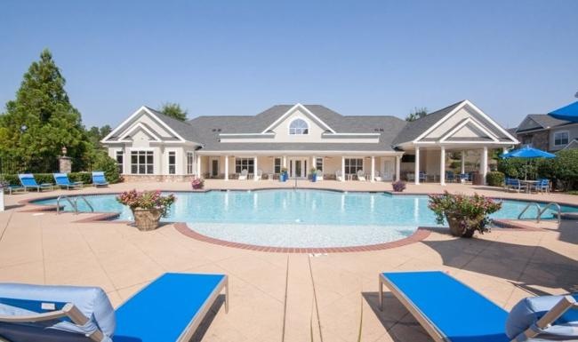 a swimming pool in front of a house