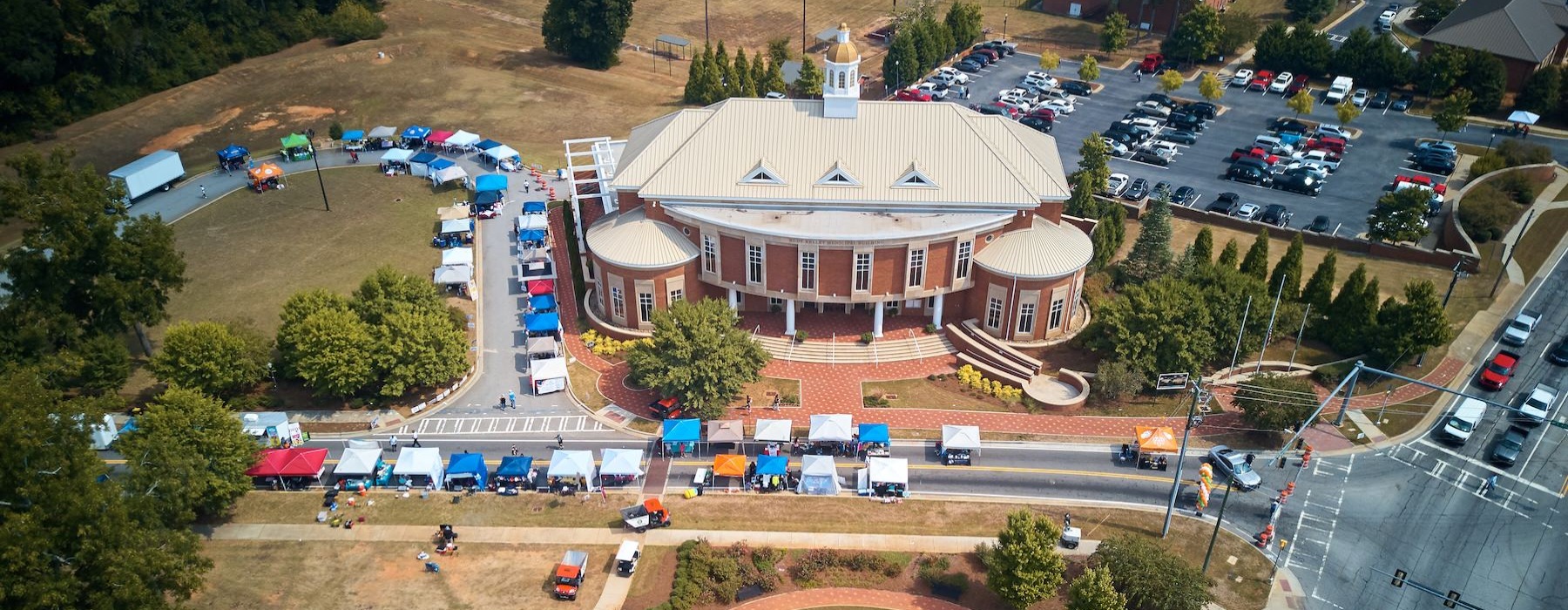a large building with a courtyard and a parking lot